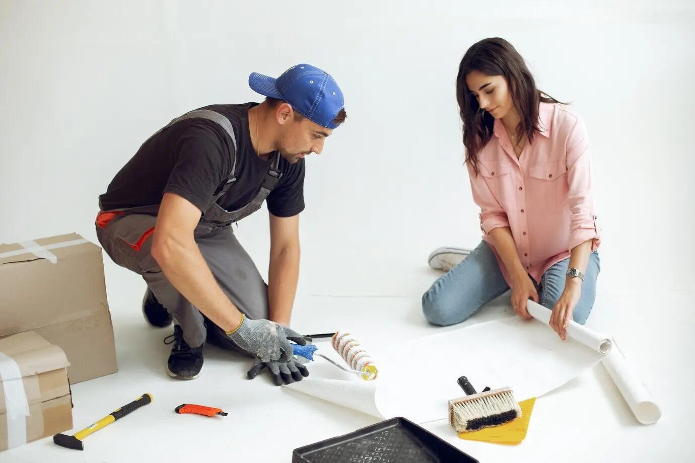 The cute, young family is fixing the room.